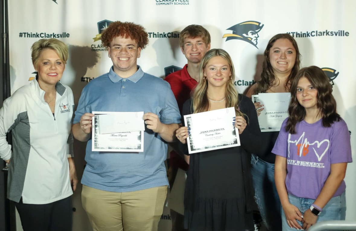 Clarksville students accepting scholarship.